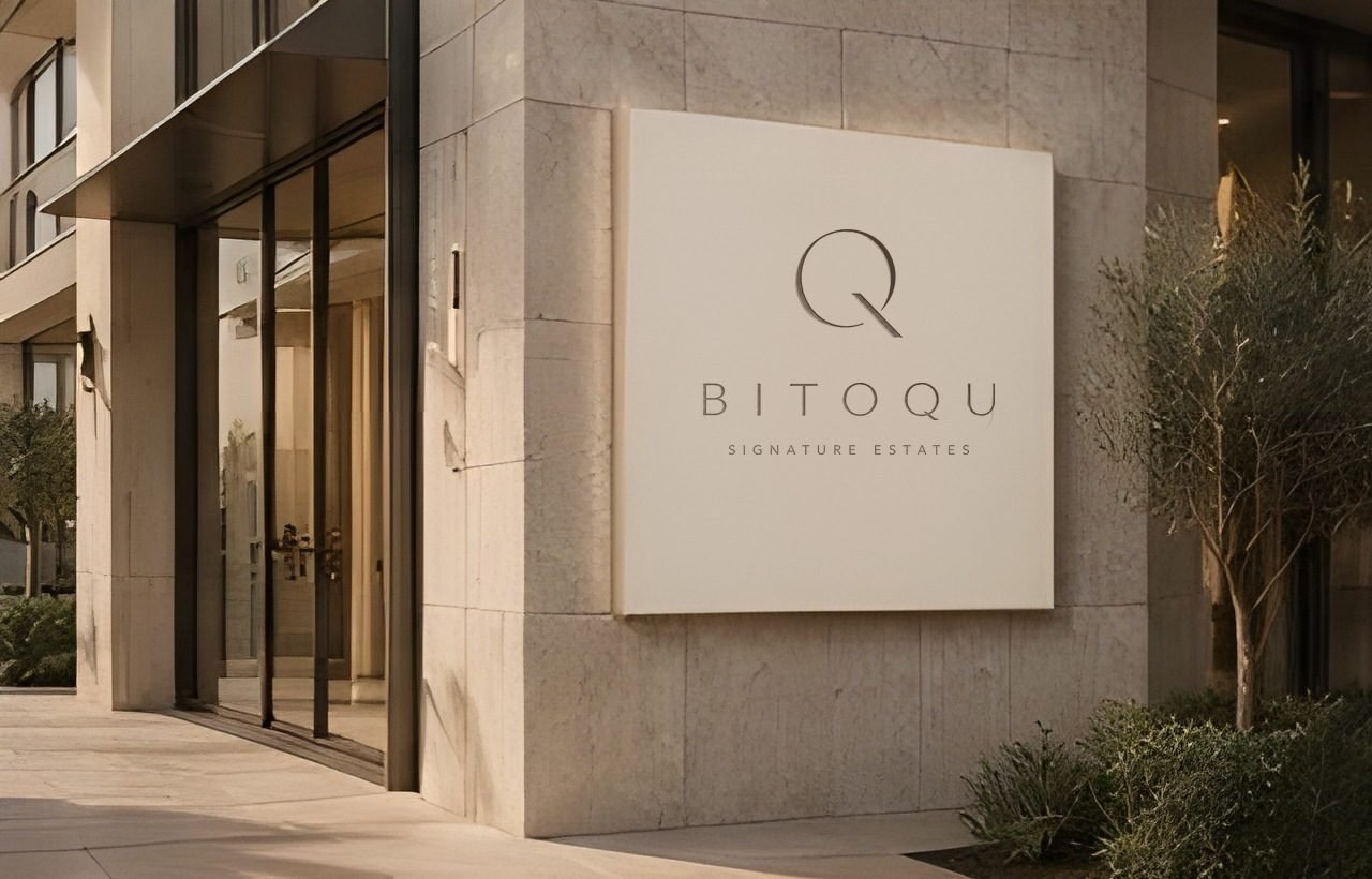 BITOQU Signature Estates sign on a limestone façade
